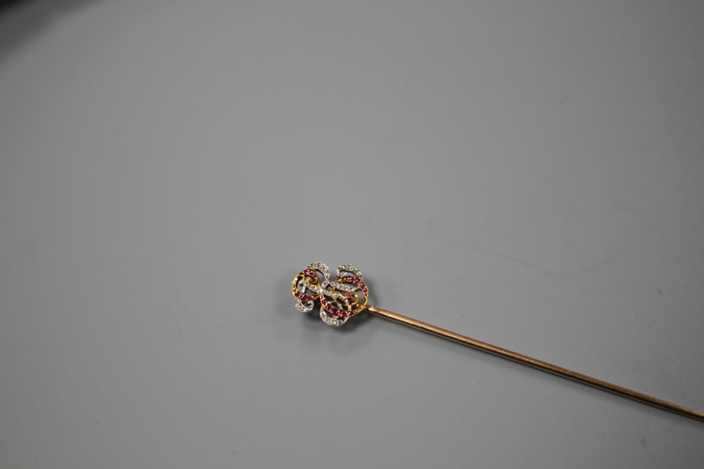 An early 20th century French yellow metal (poincon marks for 18ct), ruby and diamond stick pin, with ER? monogram terminal,